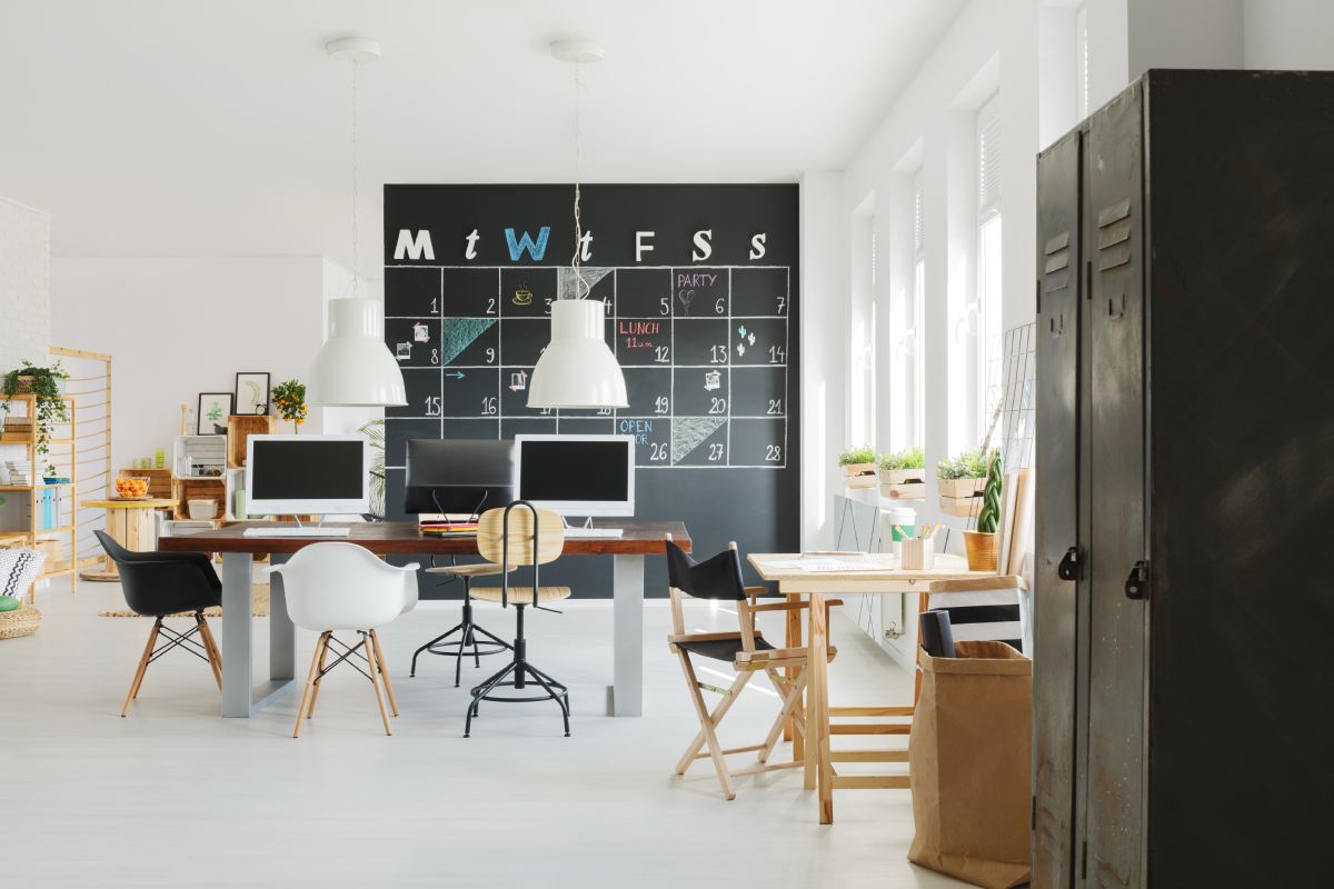 New design office with white wall and blackboard calendar