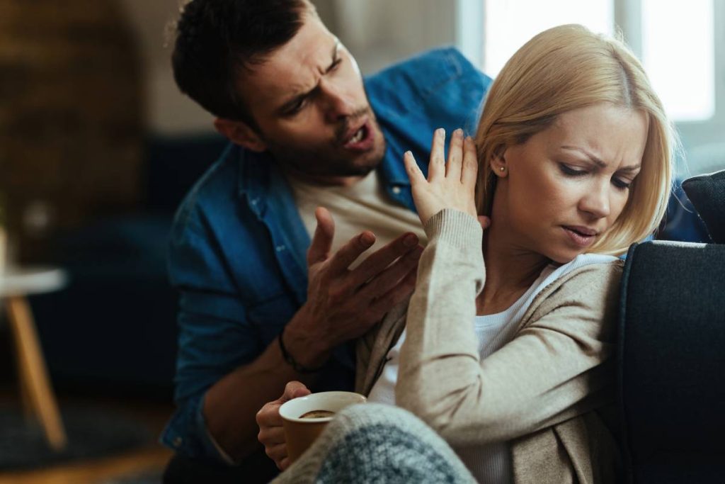 Young couple with relationship difficulties arguing about their problems at home.