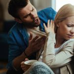 Young couple with relationship difficulties arguing about their problems at home.